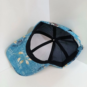 Detail of blue denim baseball cap featuring breathable mesh lining and metal buckle closure