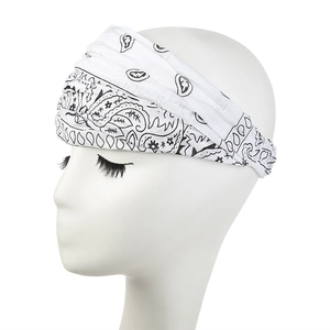 Detail of white paisley printed headband with elastic pleated texture and bohemian floral pattern