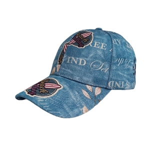Classic washed blue denim baseball cap featuring beach themed prints and curved brim