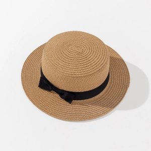 Detail of the high-quality woven texture and black ribbon bow on a boater straw hat