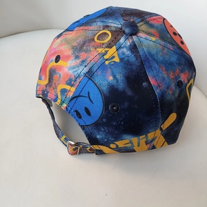 Detail view of cotton tie-dye baseball cap featuring street style print and metal buckle
