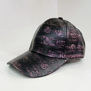 Detail of black PU leather baseball cap with purple metallic skull and crossbones relief