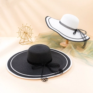 Elegant wide brim straw sun hats with black and white bowknots for summer beach vacations