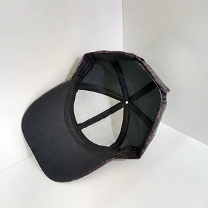 Detail showing the internal six-panel structure and reinforced seams of the PU leather cap