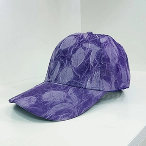 Detail showing the deep purple baseball cap with unique 3D wrinkled marble texture fabric