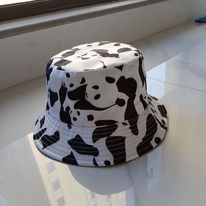 Detailed view of canvas bucket hat featuring black and white panda pattern and stitch details