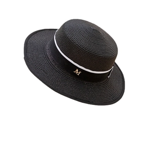 Elegant black straw boater hat with white trim, black ribbon and golden M logo detail