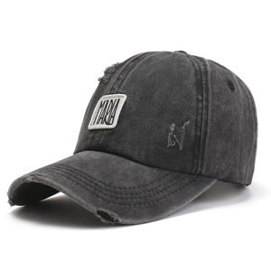 Detailed macro view of a vintage distressed baseball cap with embroidery and frayed edges