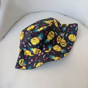 Reversible bucket hat in black with funny pineapple print illustrations for summer wear