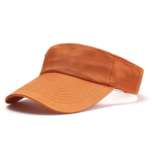 Close-up of vibrant orange sun visor hat with reinforced stitching on the curved brim