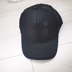 Detail of tiger print trucker hat with breathable mesh back and foam front panel