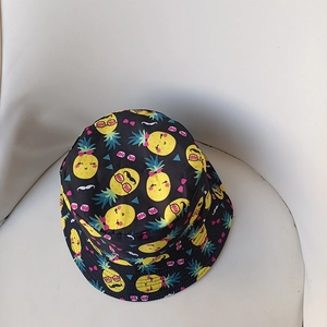 Detail of black cotton bucket hat featuring all-over cartoon pineapple print patterns