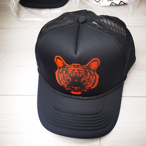Black mesh trucker hat with a bold red tiger graphic on front, curved brim breathable cap