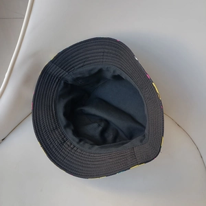 Detail of reversible bucket hat showing internal black lining and colorful pattern stitching