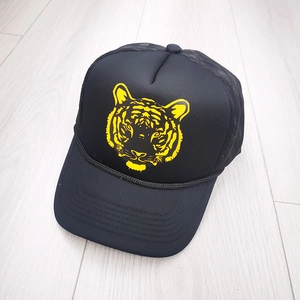 Black trucker hat with yellow tiger print and breathable mesh back for sun protection
