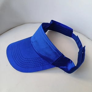 Detail view of the bright blue visor cap showing parallel stitching and fabric texture