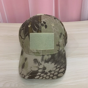 Detailed macro view of khaki honeycomb camouflage tactical cap with front velcro patch
