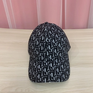 Detailed macro view of black and white baseball cap with Eiffel Tower and H letter patterns