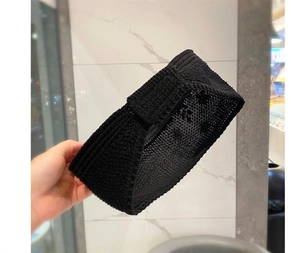 Detailed view of the black knit texture and elastic braided pattern of the sun visor hat