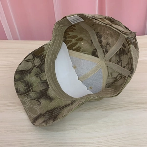 Detail view of camouflage baseball cap showing interior lining and 100% acrylic care label