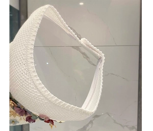 Detailed macro view of white woven sun hat with colorful 3D flowers and velcro strap