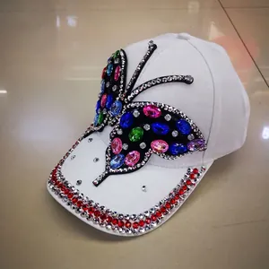 White baseball cap featuring vibrant multi-color crystal butterfly design and rhinestone brim