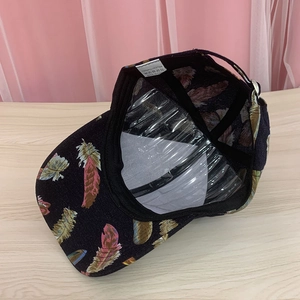Detail view of polyester baseball cap interior showing feather print and fabric care label