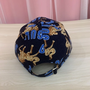 Detail of navy cotton baseball cap with horse print and adjustable silver metal buckle
