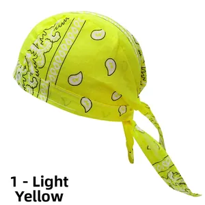 Detail view of fluorescent yellow cotton paisley bandana showing fabric texture and ties
