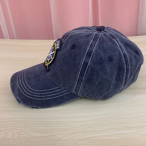 Detail of vintage washed cotton baseball cap with Marine embroidery and contrast stitching