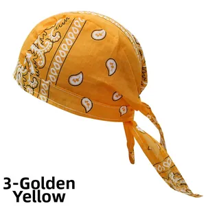 Detail of golden yellow paisley pirate headscarf showing cotton texture and straps