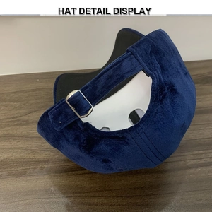 Detail display of navy blue suede baseball cap showing the adjustable metal buckle strap