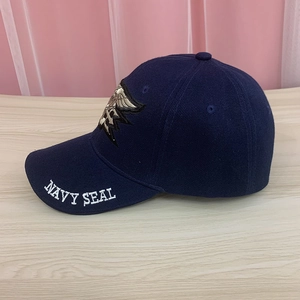 Detailed close-up of navy blue tactical cap featuring Navy Seal trident embroidery