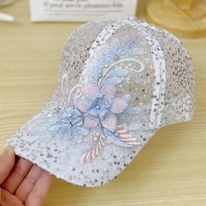 Detail of floral lace mesh baseball cap with silver sequins and pearl floral embroidery