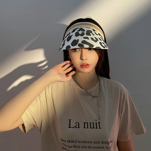 Detail of sun visor hat with black and white animal print and fine woven texture