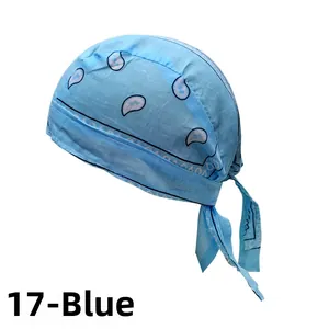 Detail of jade blue paisley bandana cap with adjustable ties and cotton texture