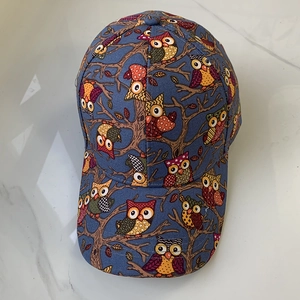 Close-up of owl and branch pattern on the cotton crown of this stylish baseball cap