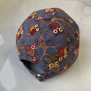 Detail view of cotton owl print baseball cap with adjustable silver metal buckle