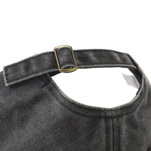 Close-up of the vintage washed denim baseball cap with an adjustable bronze metal buckle