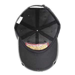 Detail of washed cotton baseball cap with distressed brim, embroidery and metal buckle