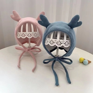 Cute knitted baby earflap hats with small antlers and ties in pink and blue colors
