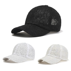 Detail of mesh baseball cap showing heart embroidery and breathable lace texture