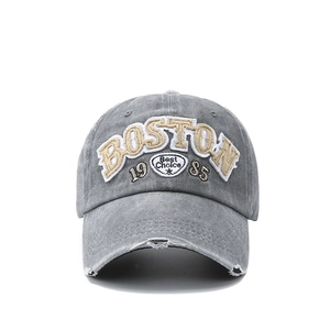 Detail showing vintage washed grey denim cap with Boston 1985 embroidery and distressed brim