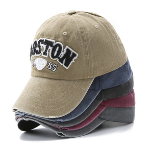 Close-up of vintage washed cotton baseball caps with Boston 1985 3D embroidery detail