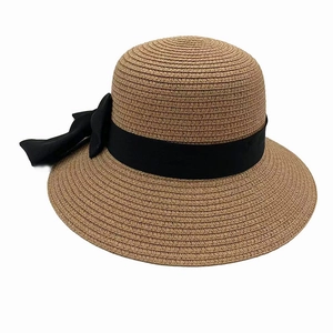 Detailed view of the woven sun hat with black satin ribbon and large elegant bow