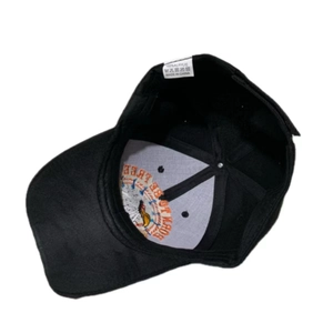 Internal view of the black baseball cap showing the embroidery and acrylic washing label
