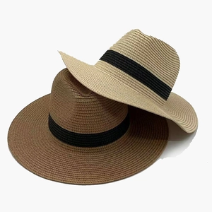 Classic Panama style straw hats in beige and brown with black ribbon bands for sun protection