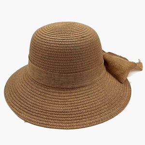 Elegant brown straw sun hat with a large bow decoration and wide brim for beach vacations