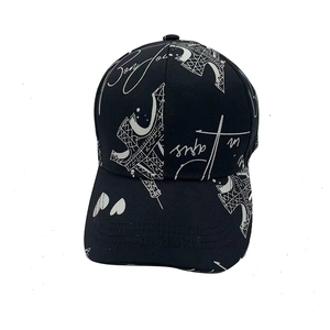 Black cotton baseball cap featuring white Eiffel Tower graffiti and Bonjour text