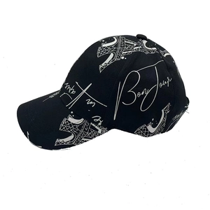 Detail of Eiffel Tower and Bonjour graffiti print on black canvas baseball cap